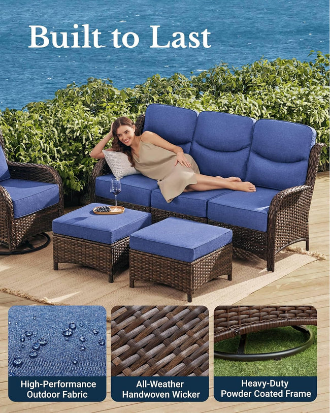 Woman relaxing on a patio set with blue cushions, surrounded by greenery and water.