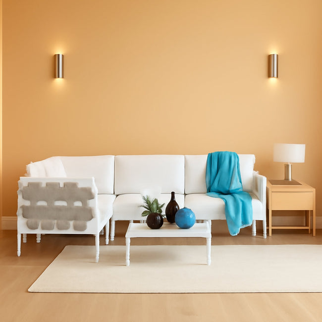 Modern living room with a white sofa, coffee table, and decorative items.