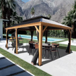 Wooden gazebo with outdoor furniture near a pool and mountains