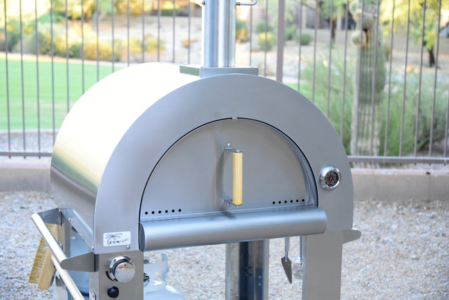 Outdoor pizza oven with a blurred garden background