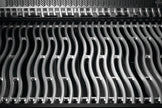 Close-up of a metallic grid with wavy pattern