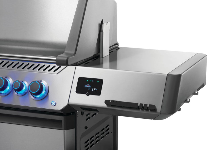 Stainless steel gas grill with control knobs and digital display on a white background