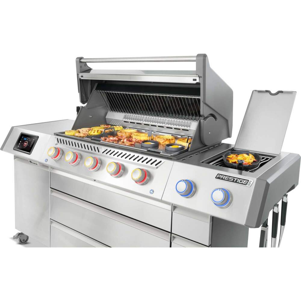 Stainless steel grill with food on a white background