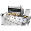Stainless steel grill with food on a white background