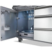 Commercial kitchen refrigerator with open door showing interior compartments.