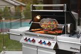 Outdoor grill with food being cooked on a patio