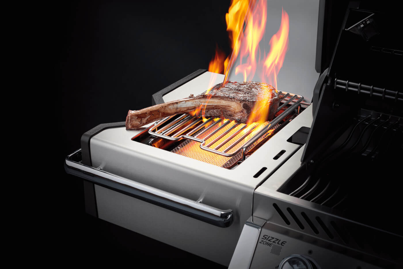 Grill with flames and a rib being cooked on a black background