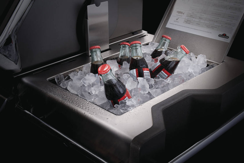 Bottles of Coca-Cola on ice in a cooler with a visible brand logo.