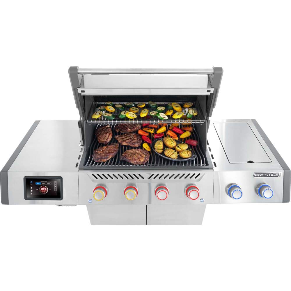 Stainless steel grill with food on a white background