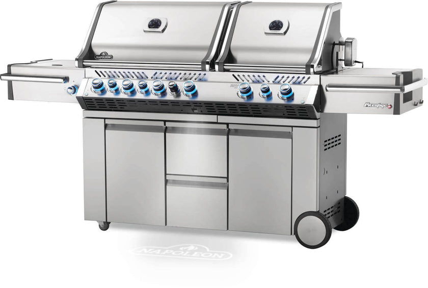 Stainless steel grill with multiple burners on a white background