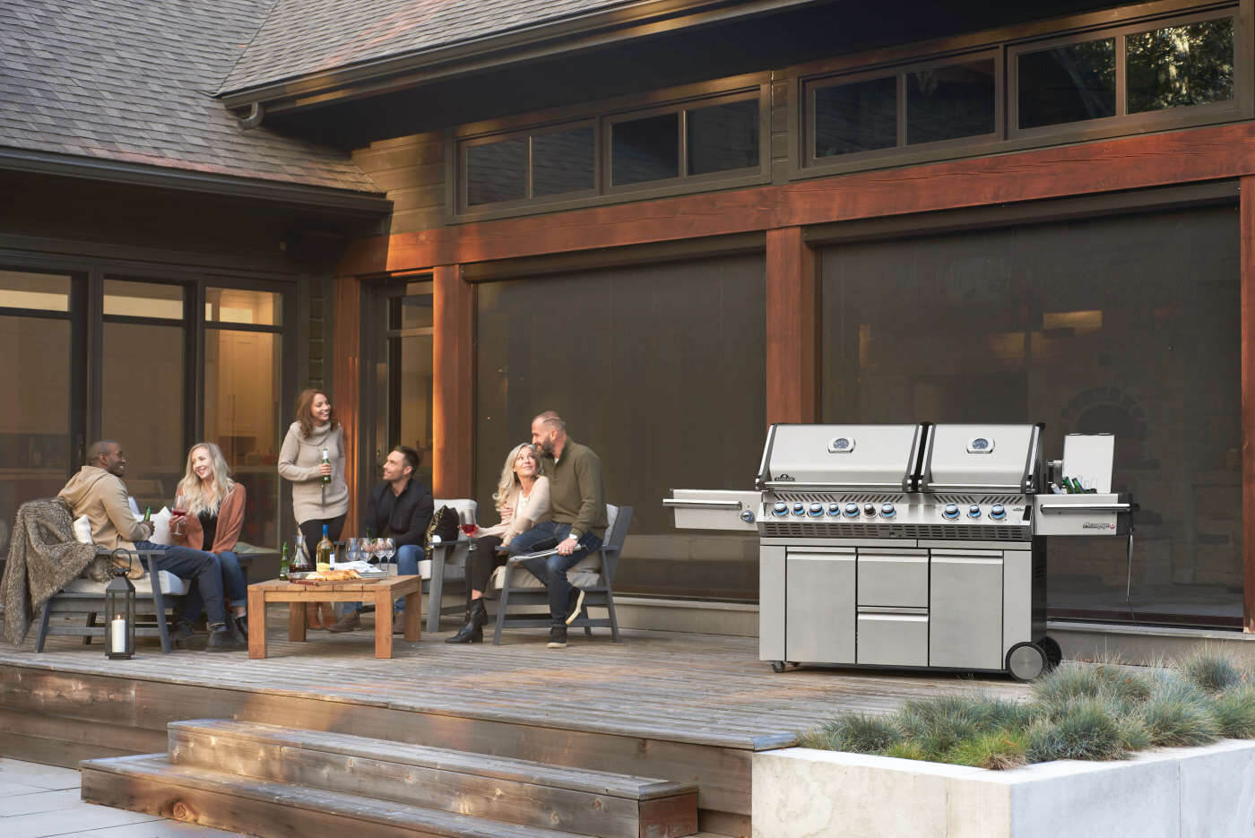 Family gathered around a barbecue grill on a patio