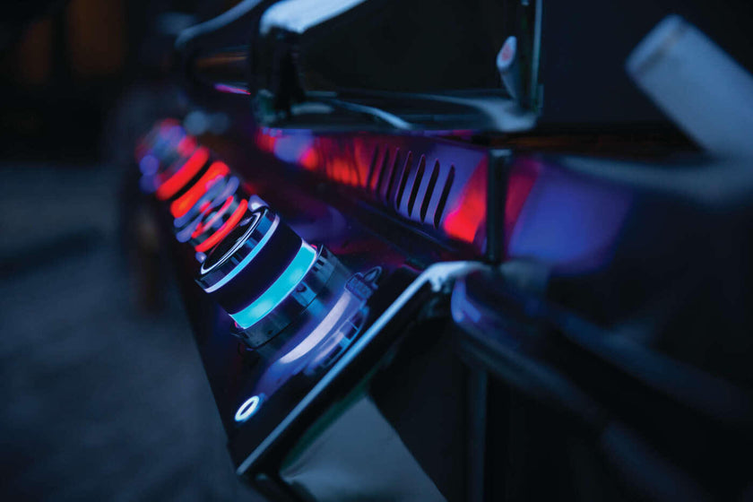 Close-up of a computer case with red LED lights on a dark background