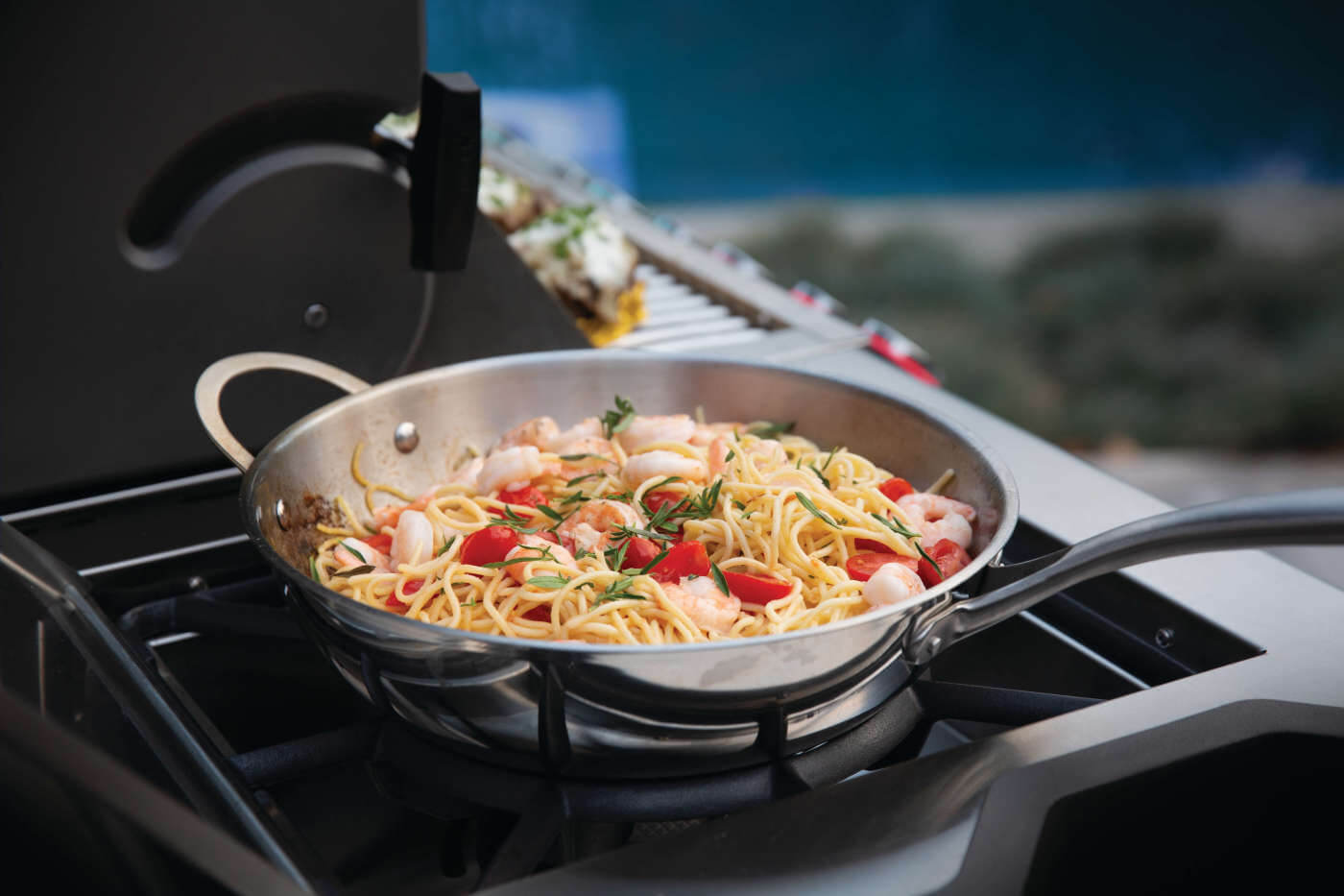 Pasta dish cooking on a portable stove outdoors