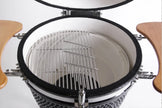 Close-up of a barbecue grill with a lid open, showing the interior.