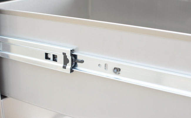 Metal drawer slide mechanism on a metallic surface