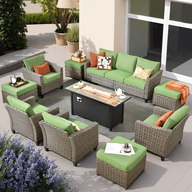 Outdoor patio furniture set with green cushions and a fire pit table.