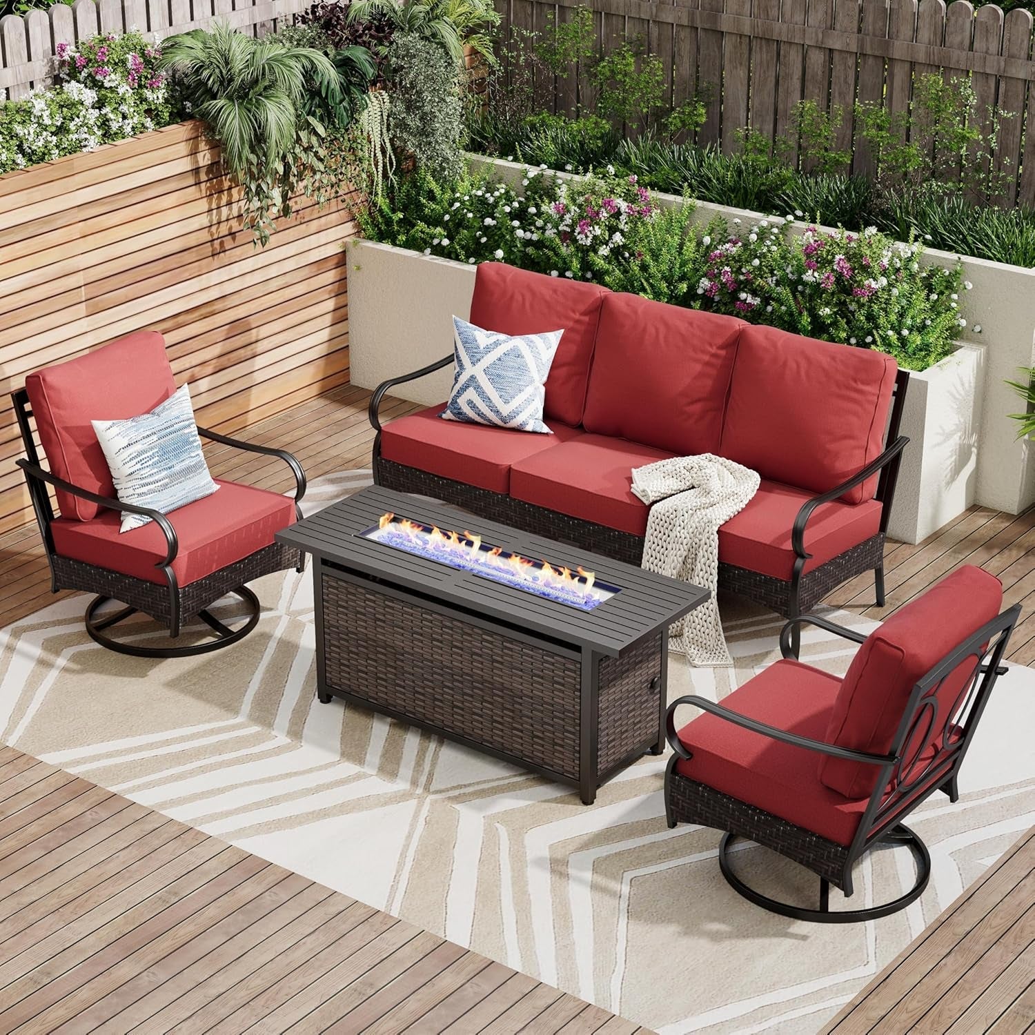 Outdoor patio set with red cushions, fire pit table, and swivel chairs on a wooden deck.